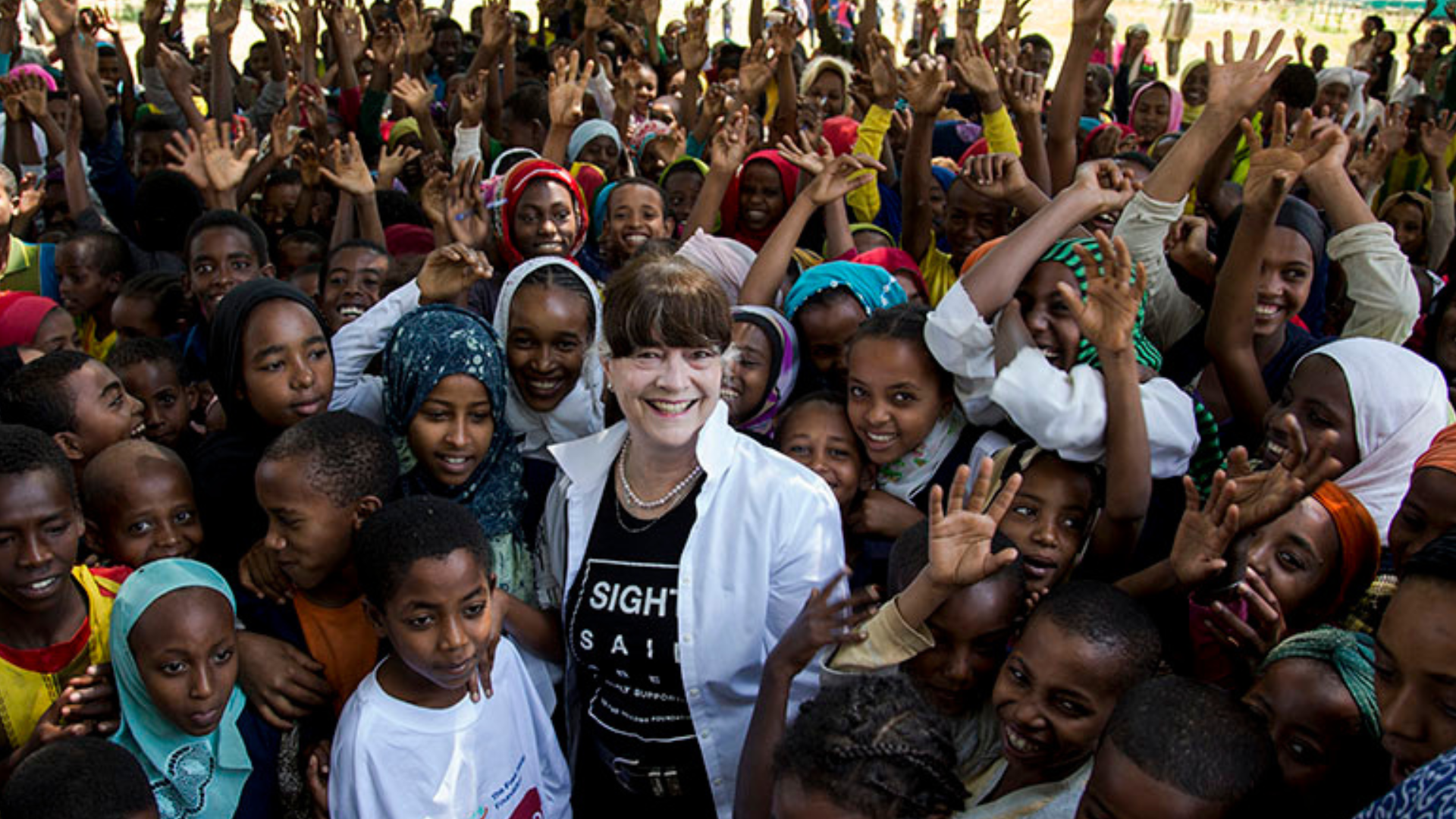 Gabi Hollows pictured in Ethiopia surrounded by happy children