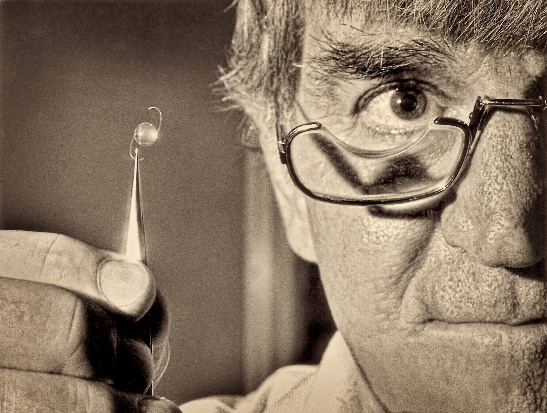 Fred Hollows holding an Australian made intraocular lens used on Eritrean patients in 1990.