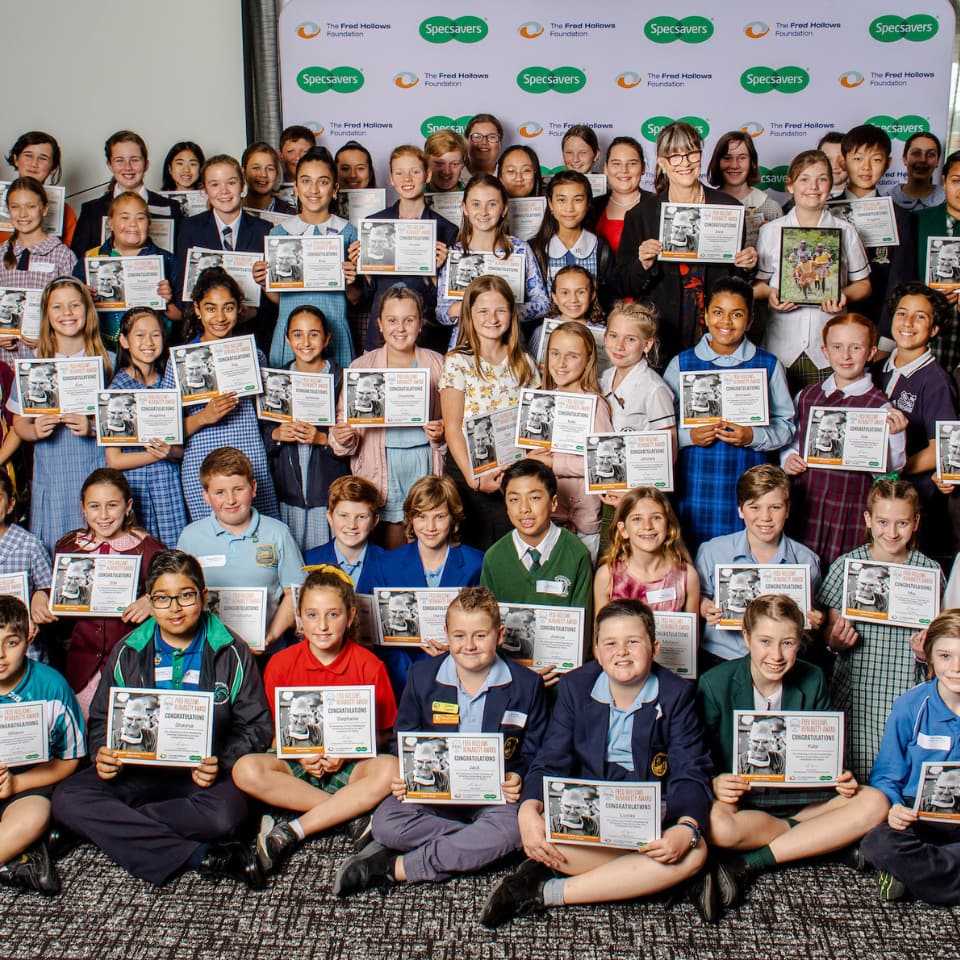 School children posing with certificates for Humanity Award