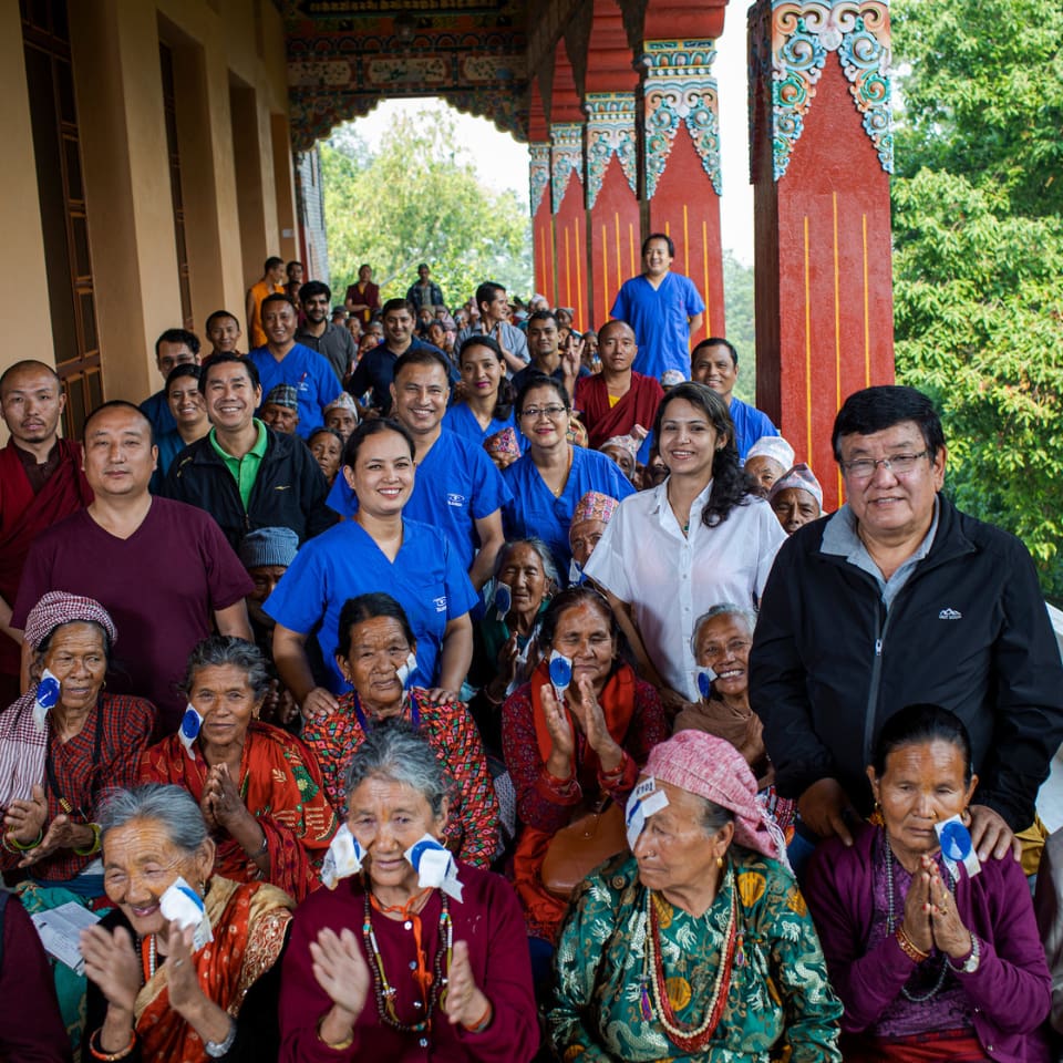 Dr Ruit standing with a group of patients and health care workers in Nepal