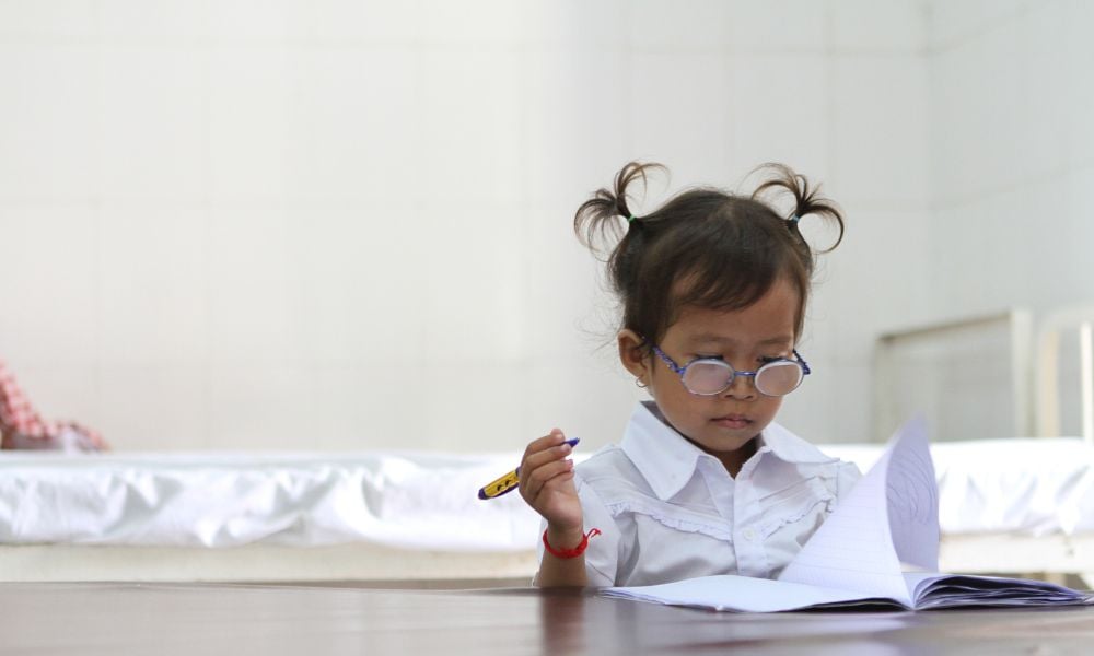 Vietnamese girl studying with glasses on