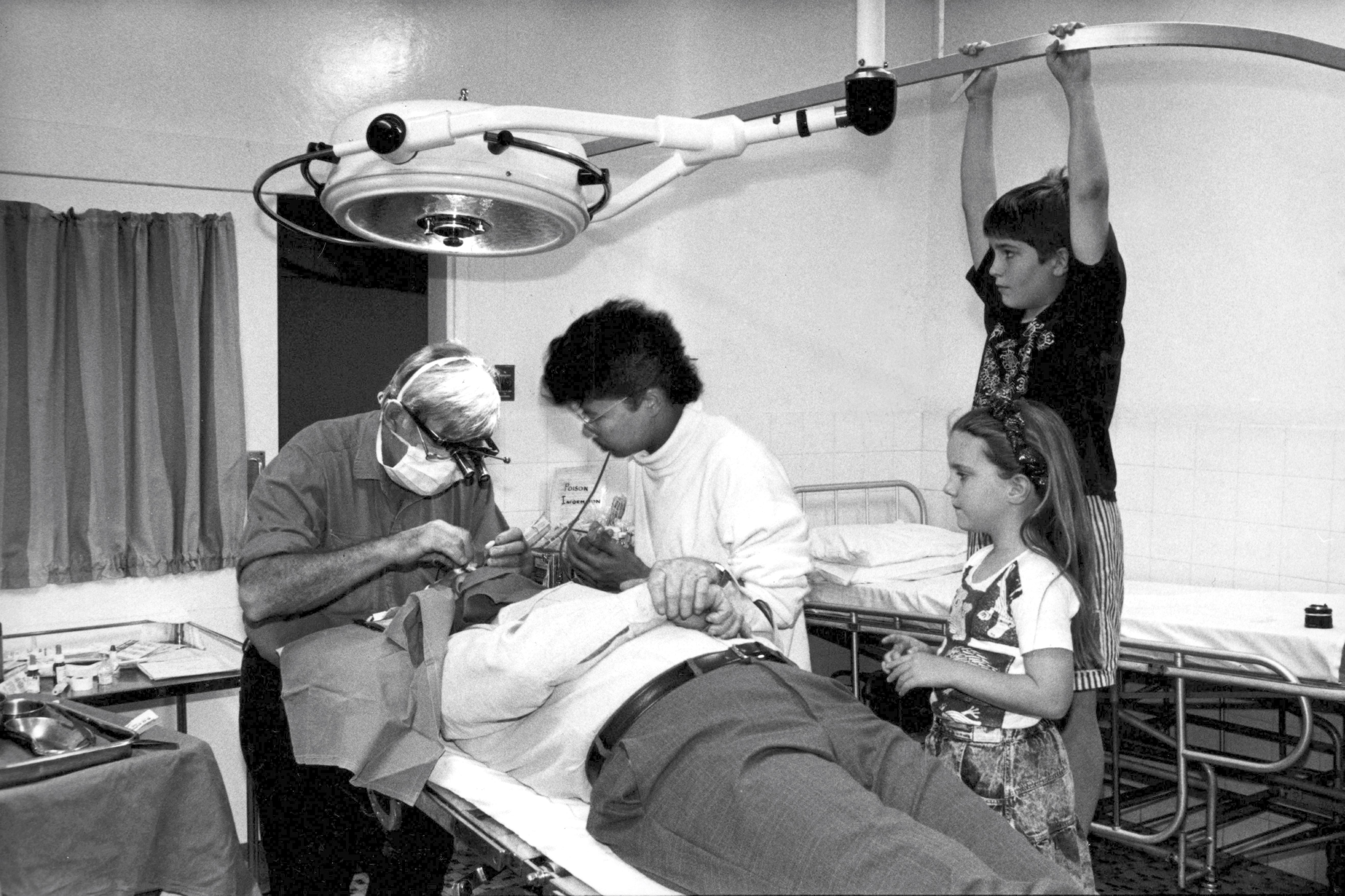 Dad operates on a patient alongside Giddhartha Ranjit from Nepal, with my sister, Emma, and I watching on and doing our best to help.  