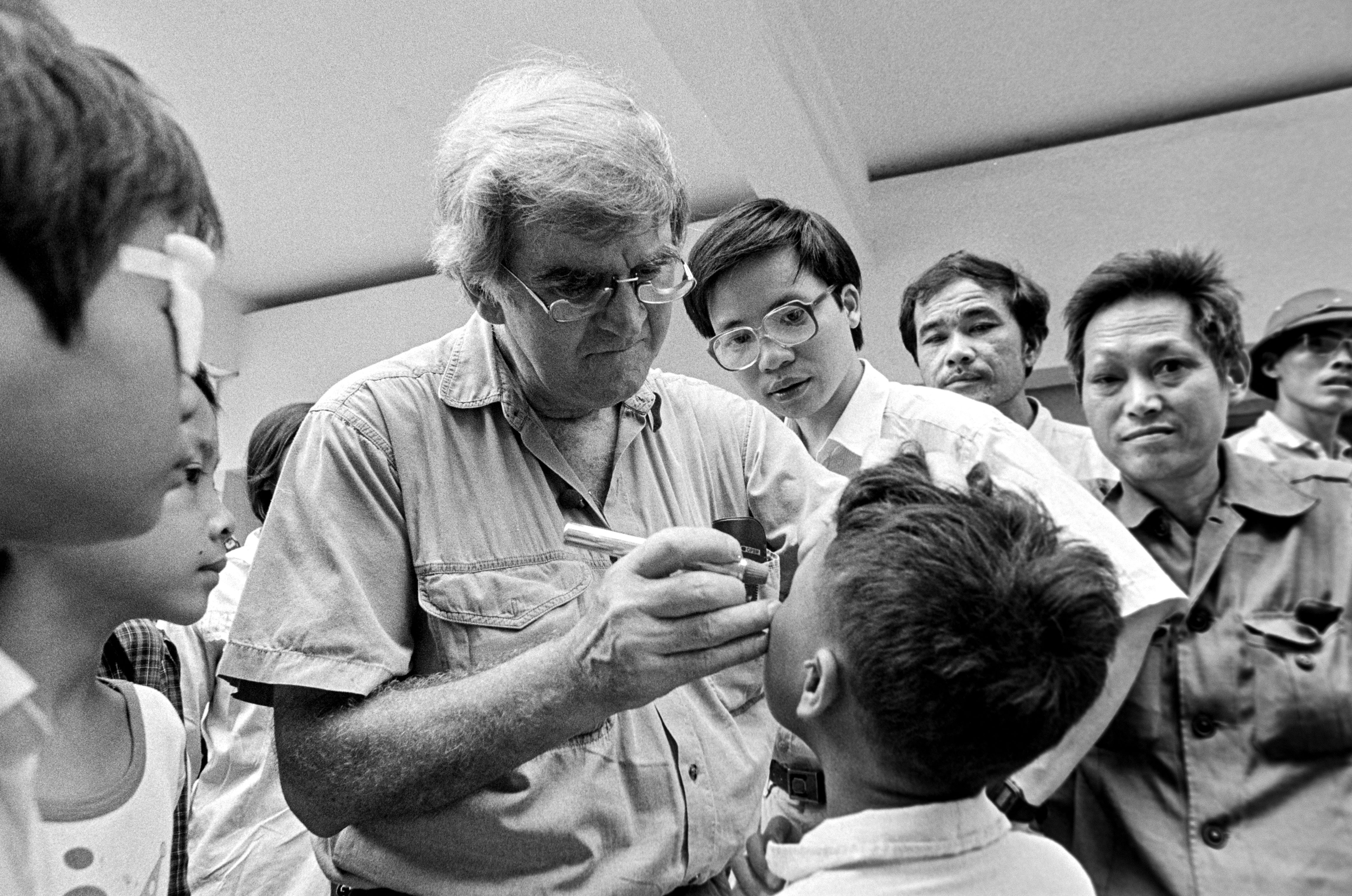 Fred examining a young boy’s eyes in Vietnam in the early ‘90s. 