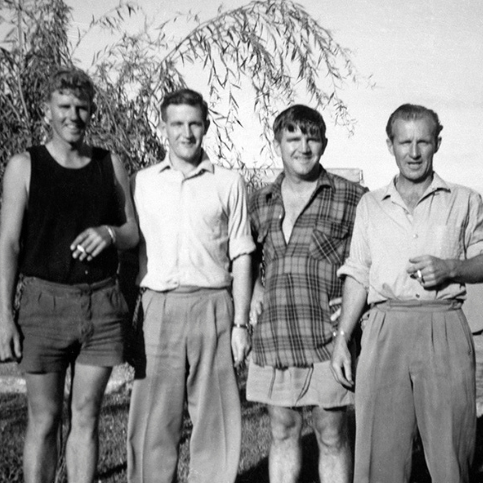 Fred Hollows (second from right) standing with his brothers posing for the camera 