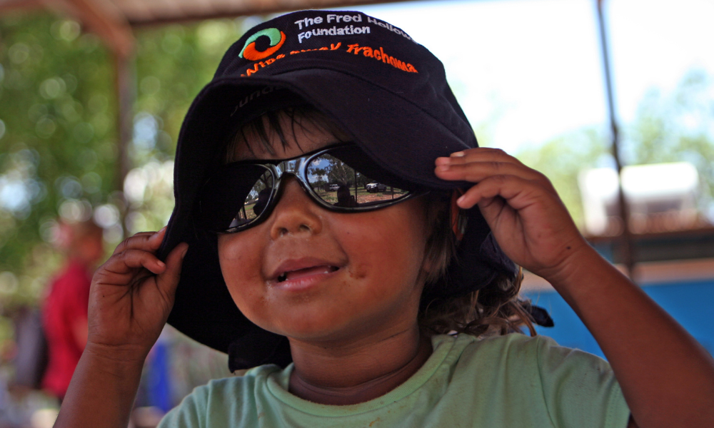 Child wearing Fred Hollows hat 