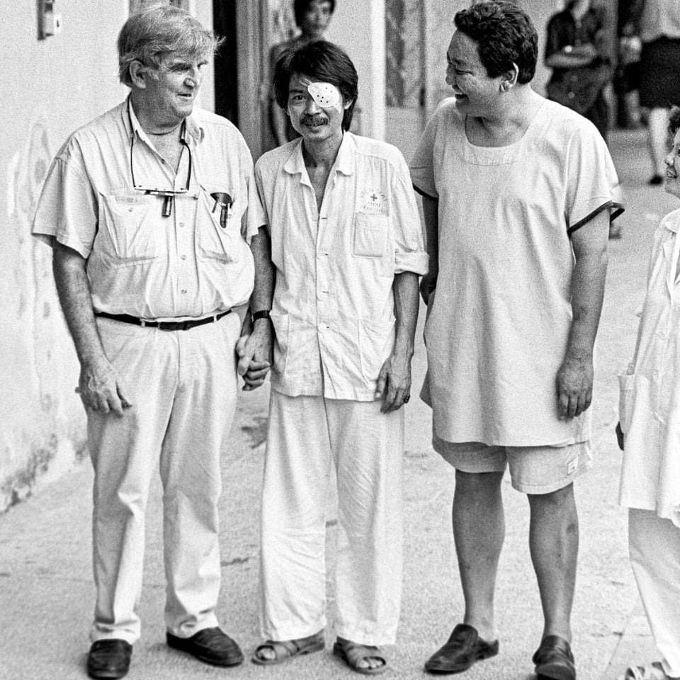 Fred and Ruit walking with a patient in Vietnam