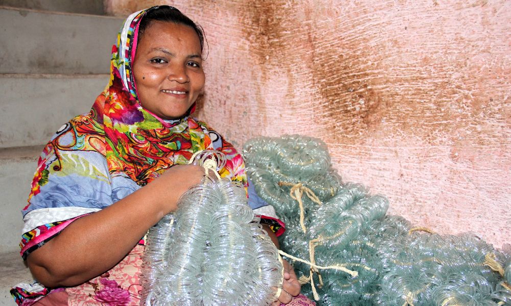 Fehmida, a 38-year-old bangle factory worker from Pakistan pictured with bangles 