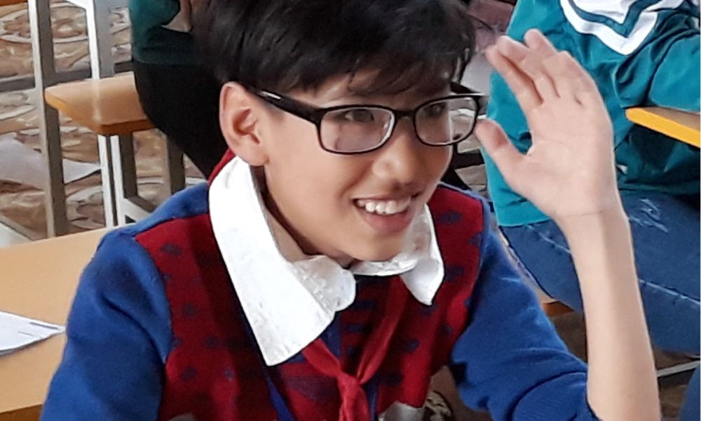 Nghia from Vietnam picture in class smiling with glasses on