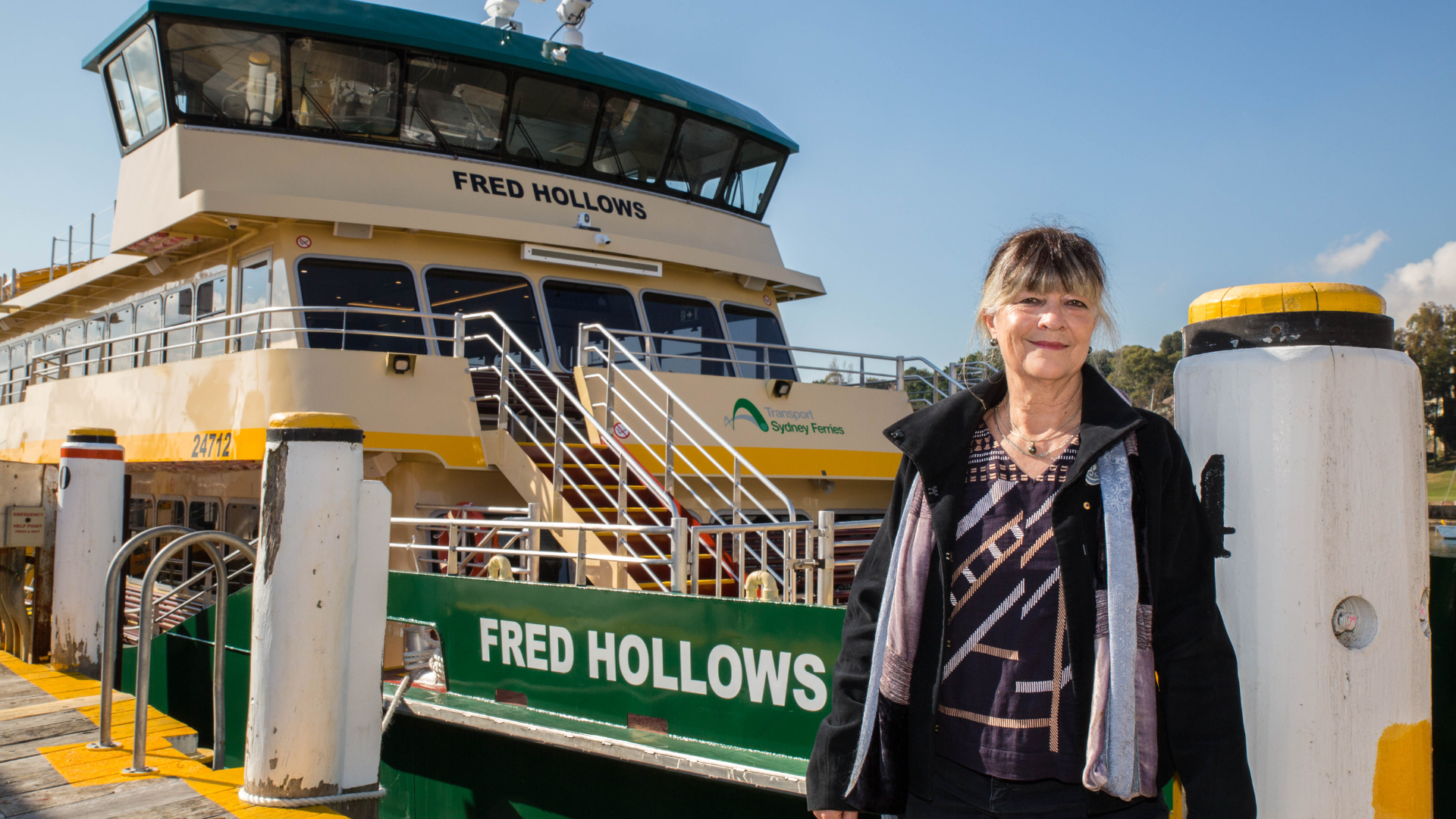 Gabi Hollows standing in front of a Sydney ferry named after Fred Hollows