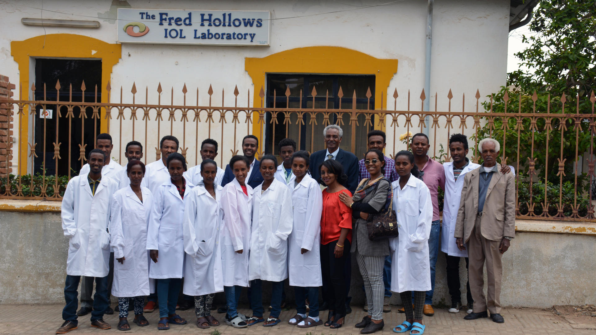 Employees standing in front of the Fred Hollows intraocular lens factory