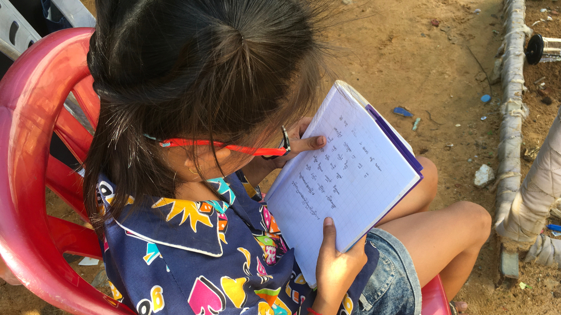 Sreyleap doing school work with her new glasses on