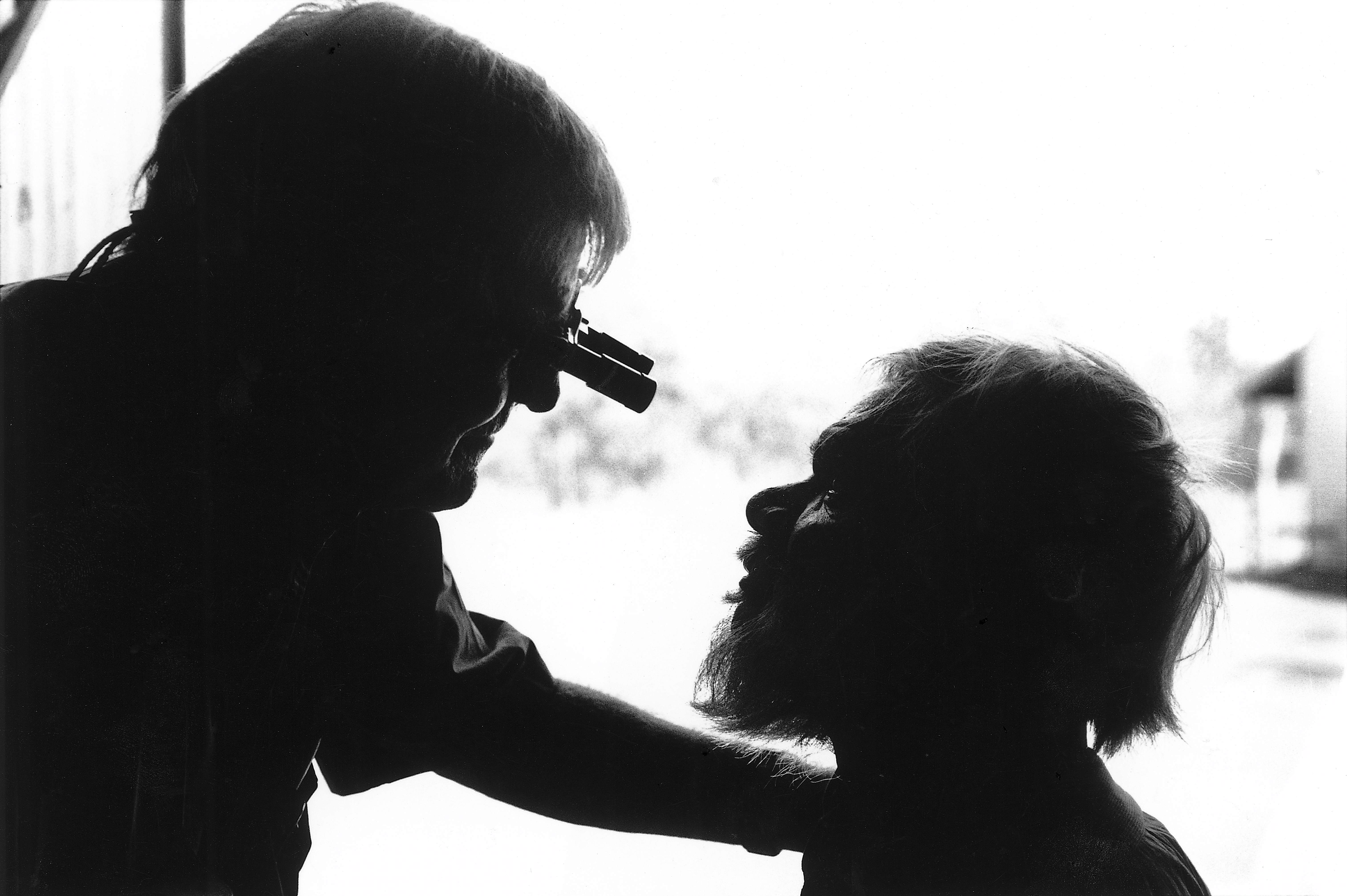 Fred Hollows examining aboriginal man's eyes