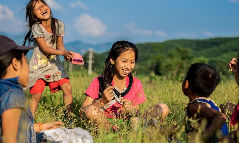 Children from LAO PDR playing in a field