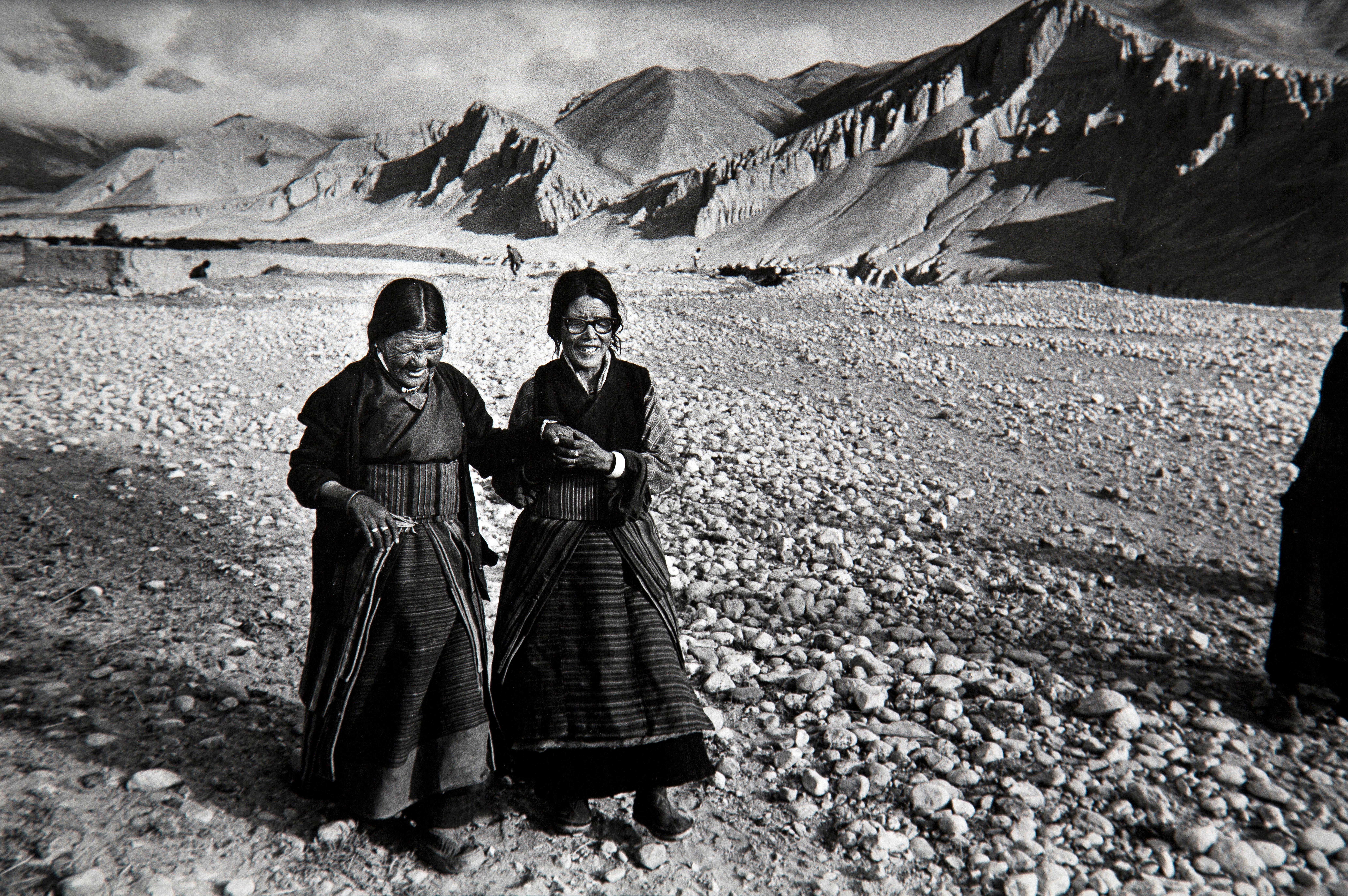 Black and white film photo of two women in Charang, Mustang in Nepal. Photo taken by Michael Amendolia in 1992.