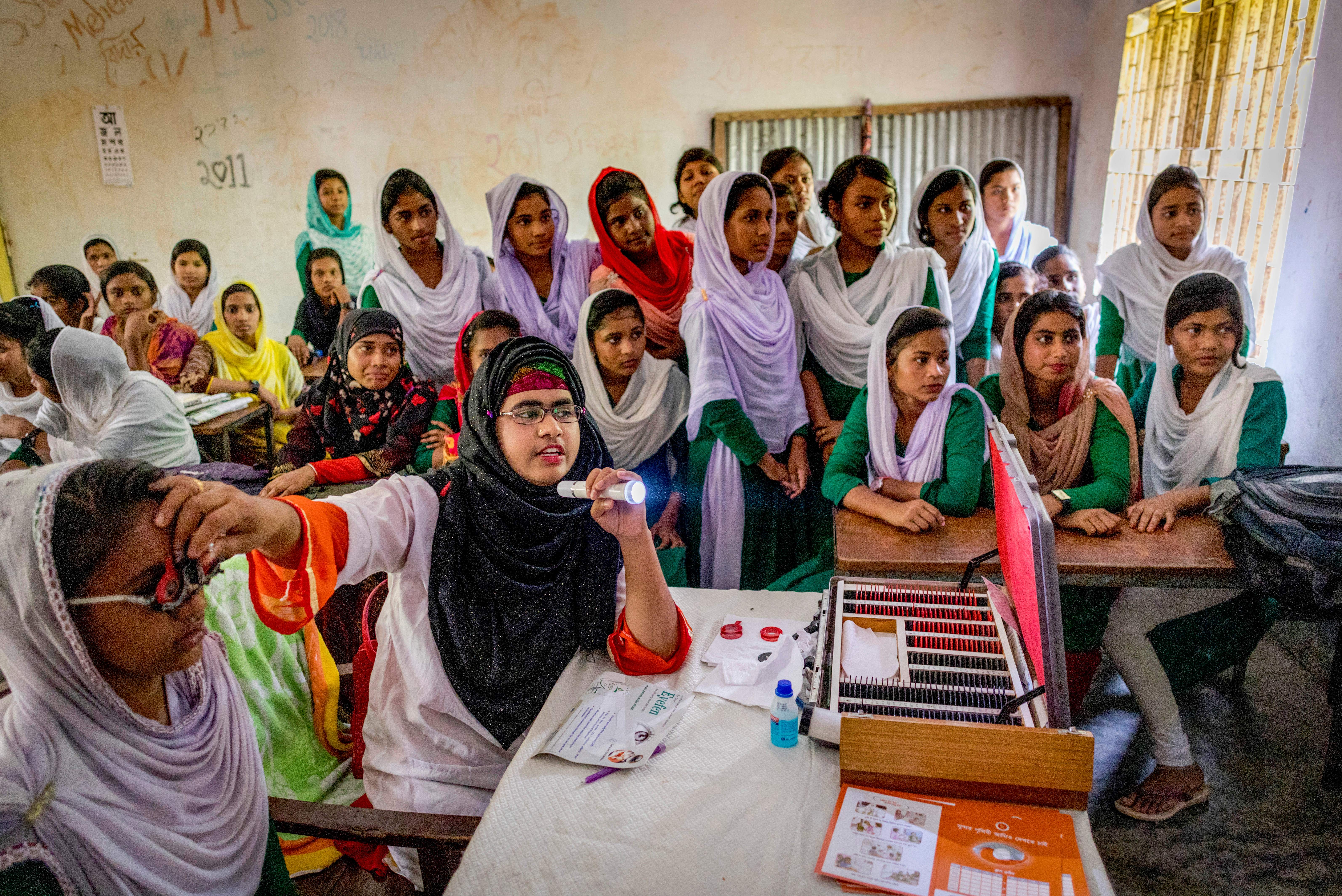 Pictured: 22-year-old Musfeka Najnin, a medical assistant, is screening Amina Secondary Girls School in Barisol students for eye issues. Taken by Michael Amendolia in Barisol, Bangladesh in 2018. 