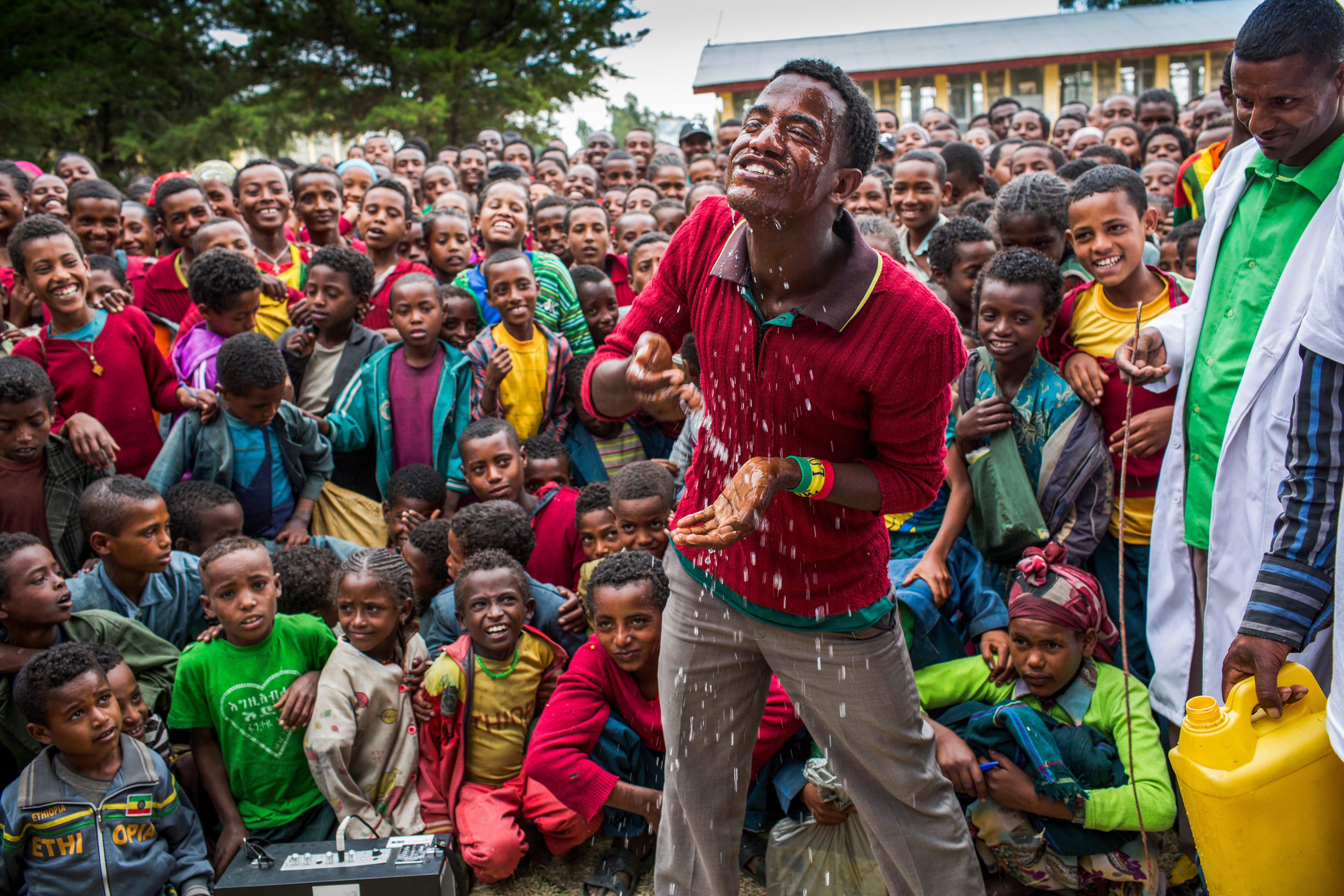 Teacher Shelmel Terefa provides trachoma education, including a demonstration of face washing, to students at a school in North Sherwa, Oromia.