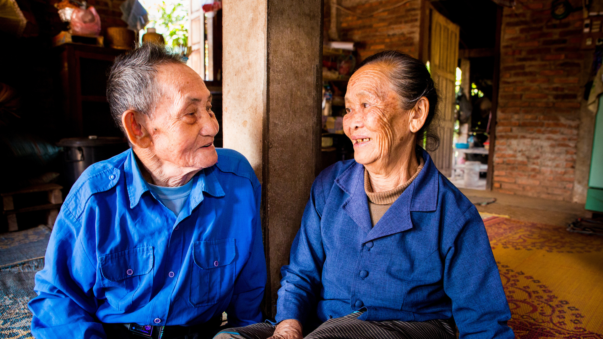 A couple from Laos looking at each other and smiling