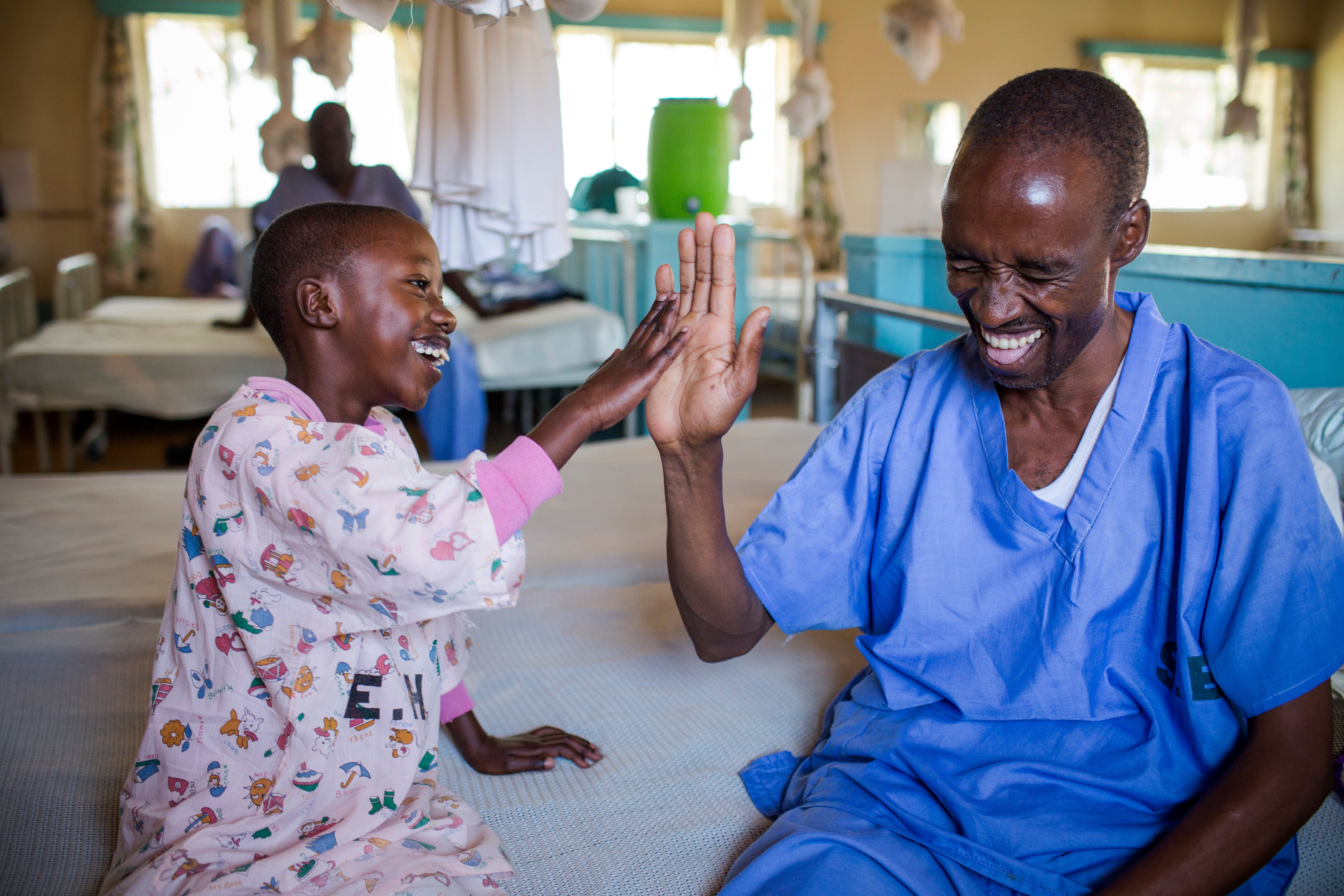 Timothy high-fives his dad after cataract surgery.