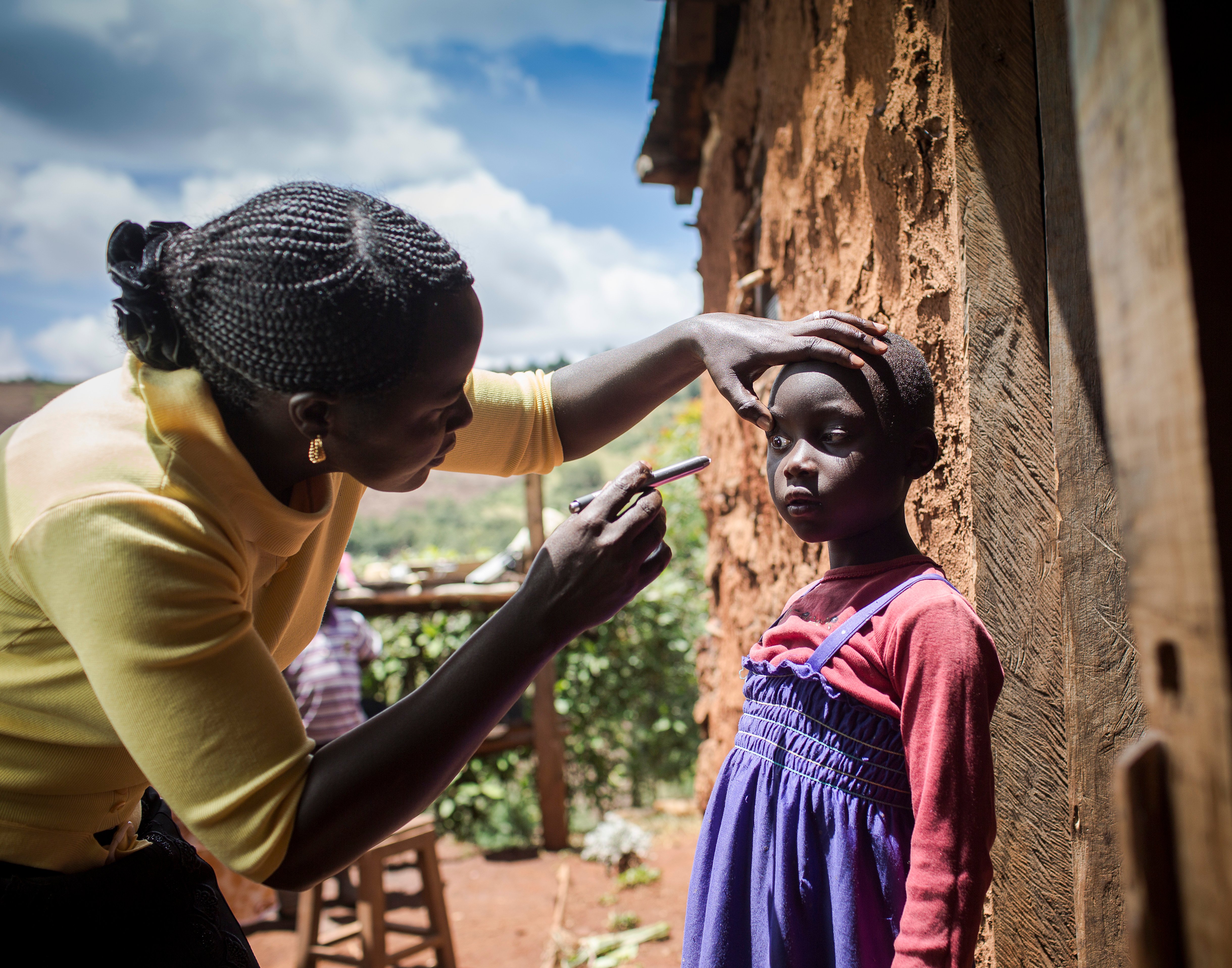 Nabiritha having an eye examination in her village by a Foundation worker